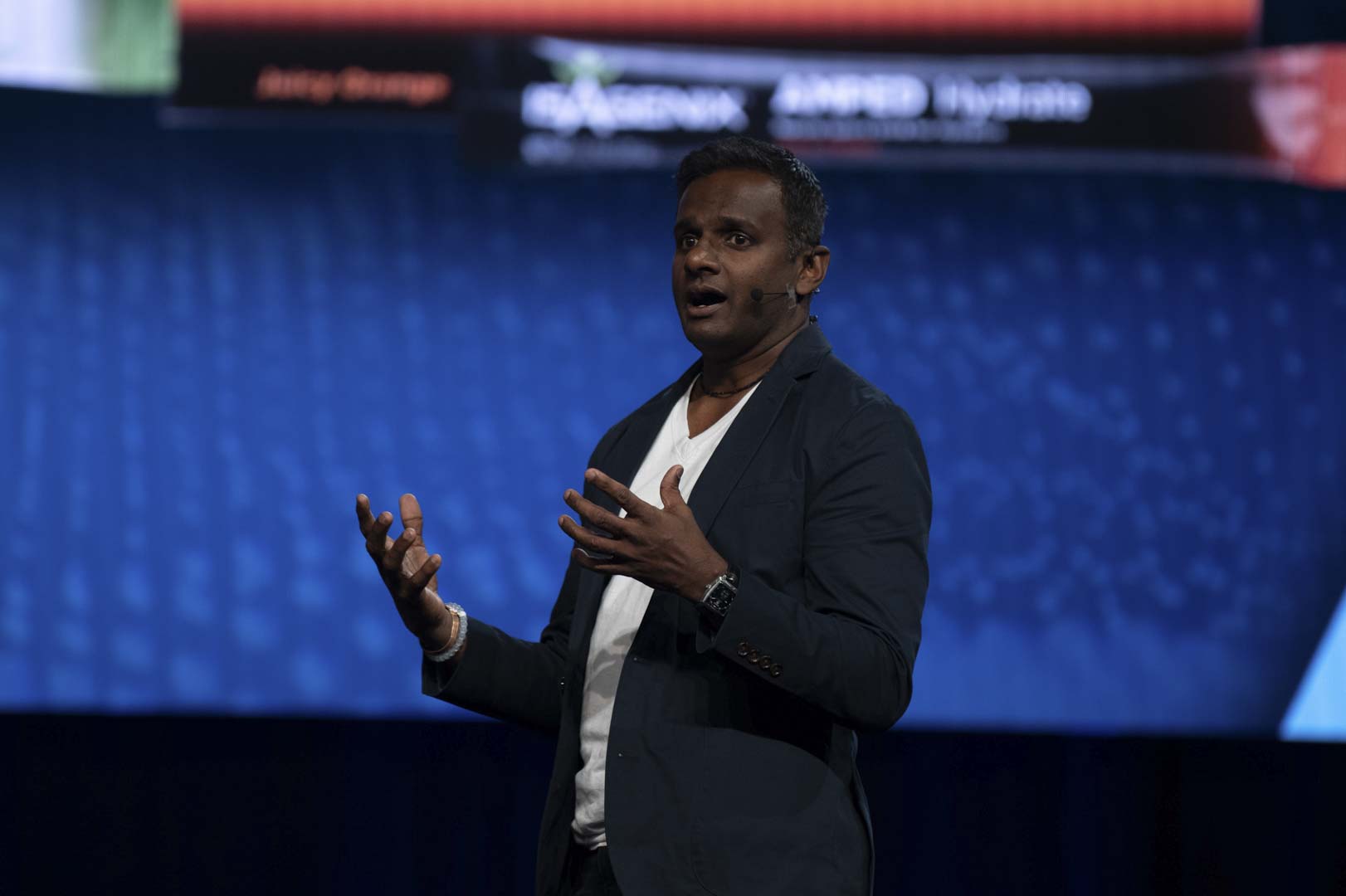 Dr Ara speaking on stage