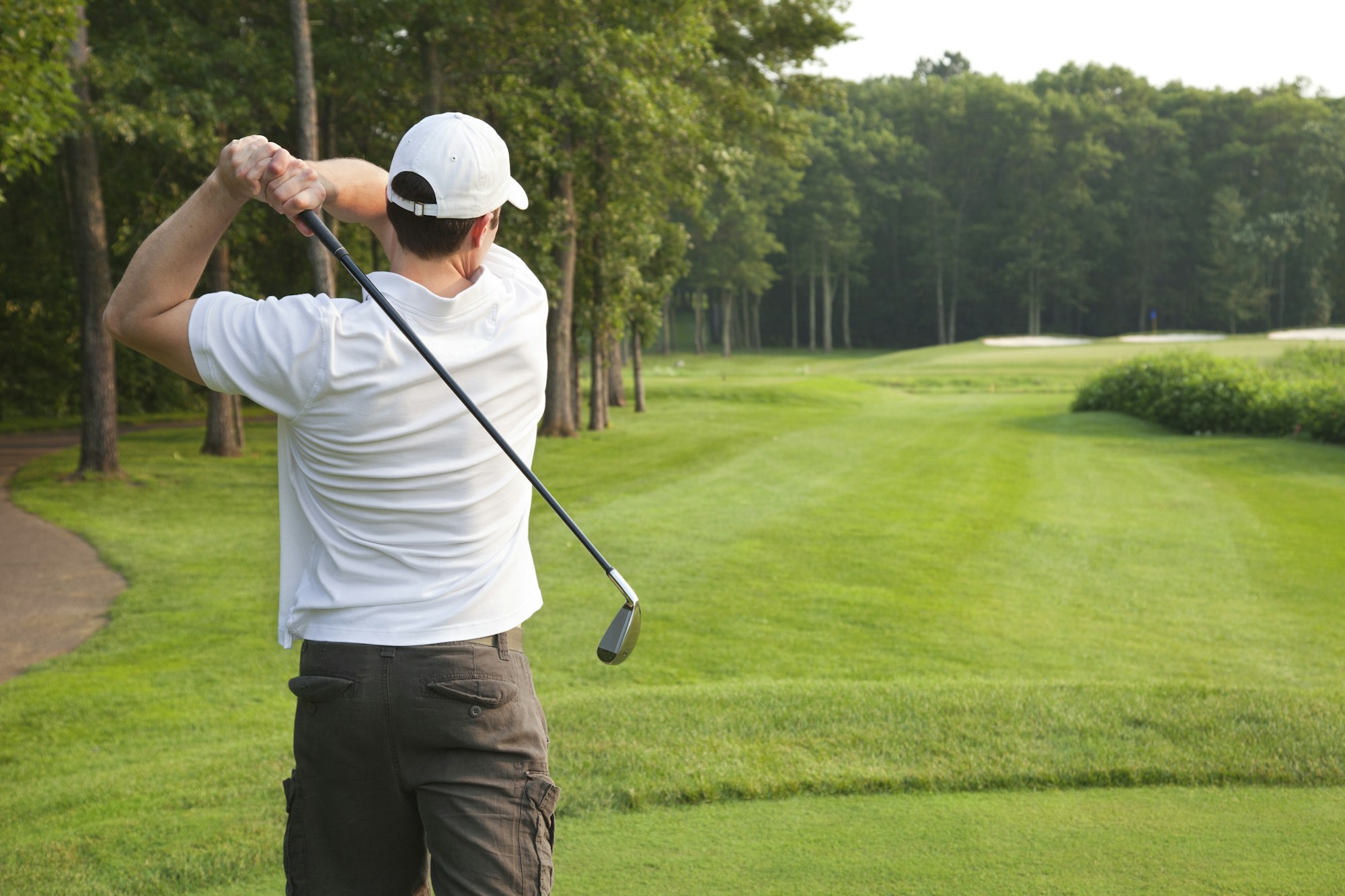 Golfer Tees Off on Golf Hole